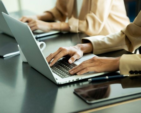 Consultant preparing documents on a laptop
